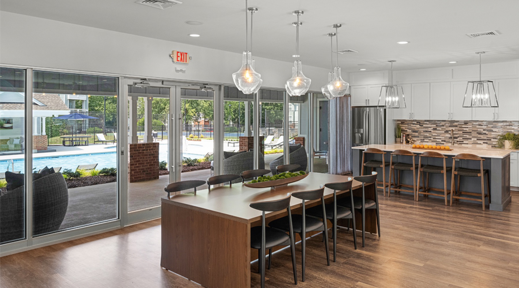Cambridge Apartments clubhouse interior with kitchen island, pendant lighting, and hardwood floors in North Raleigh NC
