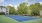 a tennis court with trees and buildings