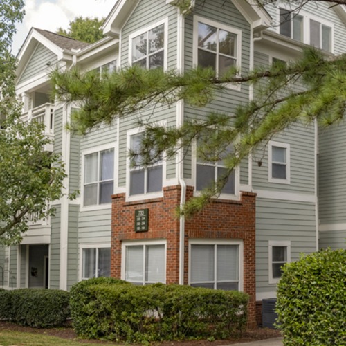 Settle into comfort at Cambridge Apartments a building with trees in front