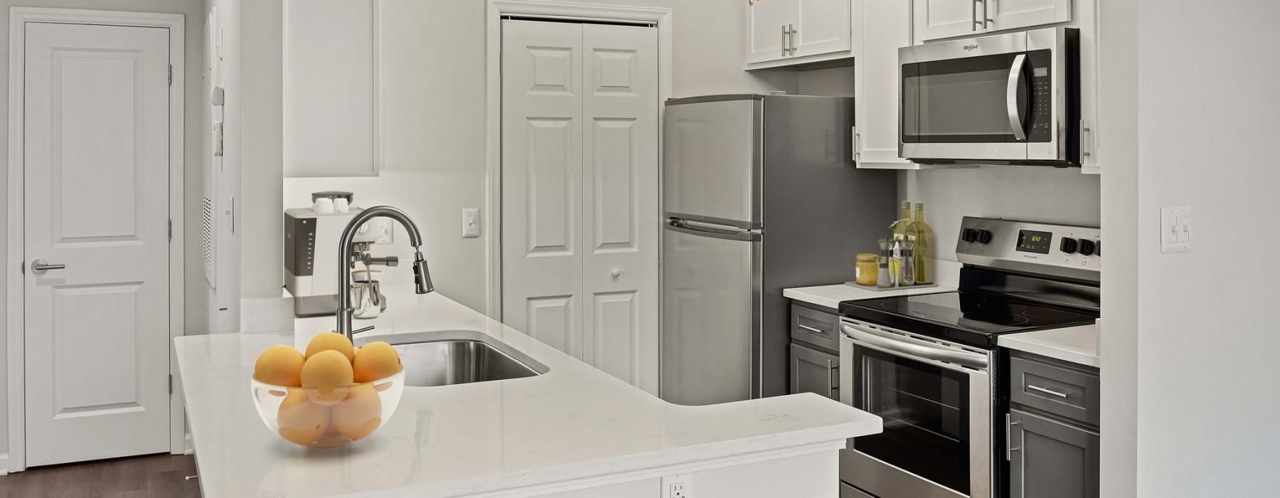 a kitchen with white cabinets and an island